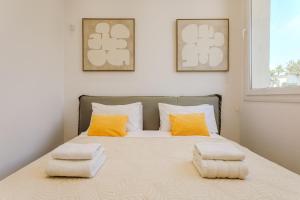 a bedroom with a bed with two pillows on it at Olymp Luxury Residence in Kissonerga