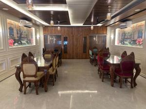 a dining room with tables and chairs in a restaurant at KK Hotel in Jaipur