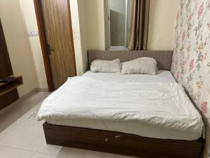 a bed with two pillows on it in a bedroom at KK Hotel in Jaipur