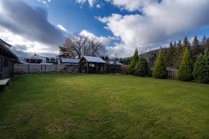 a large yard with a gazebo in a backyard at Avama - apartmány Srní in Srní