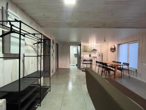 a kitchen and dining room with a table and chairs at Wald Haus in Pulʼmo +6 photos