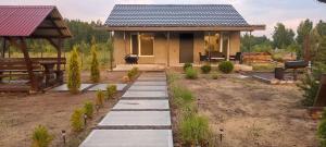a small house with a pathway leading to it at Wald Haus in Pulʼmo