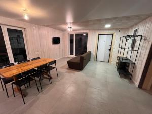 a large room with a wooden table and chairs at Wald Haus in Pulʼmo