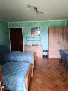 a bedroom with two beds and a dresser at Locazione breve LE ROSE in Darfo