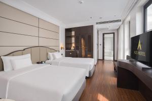 a hotel room with two beds and a television at A25 - Premium Hotel - 95 Lò Đúc in Hanoi +27 photos