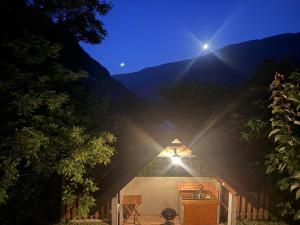 a barn with the sun shining behind it at Edi Cottage in Bovec
