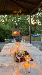 a long table with wine glasses and a fireplace at La Dimora di Armida in Torricella Peligna