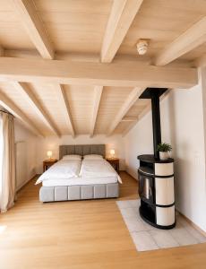 a bedroom with a bed and a wooden ceiling at Hotel Alpenblick in Klosters