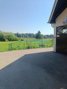 a driveway leading to a building with a view of a field at Solea Apartment in Woditz +6 photos