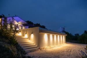 a set of stairs with lights on them at night at Villa Rinoula-private pool in Vitalades
