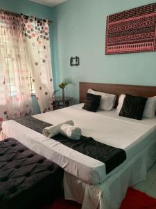 a bedroom with two beds with towels on them at MJ Marina in Mtwapa +29 photos