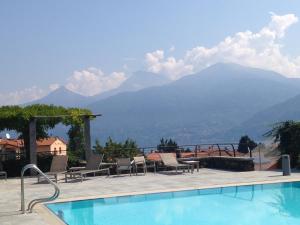 a swimming pool with a view of mountains at Le Pergole Aloha - Menaggio by LoveComo in Menaggio
