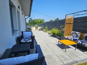 a patio with two chairs and a yellow table at Jaworze in Jaworze