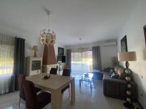 a living room with a table and a couch at Casa Boa Nova Valadares in Valadares