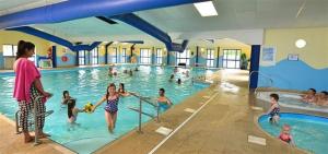 a group of children playing in a swimming pool at Dale 12 in Burgh Island