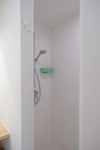 a shower in a bathroom with white walls at Villa Hartebos in Kaprijke