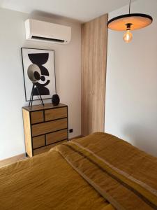 a bedroom with a bed and a dresser with a lamp at La bergerie de Cupabia in Serra-di-Ferro