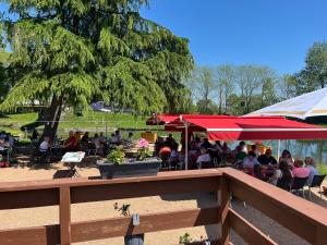 a group of people sitting at an outdoor restaurant at Les cabane in Fleury-sur-Loire