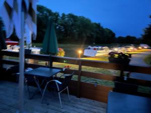 a table and chairs on a balcony at night at Les cabane in Fleury-sur-Loire