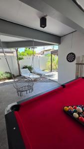 a pool table in a backyard with a swing at Villa Wongamat in North Pattaya