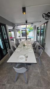 a long white table in a room with chairs at Villa Wongamat in North Pattaya
