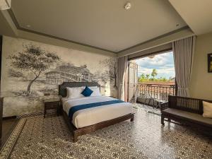 a bedroom with a bed and a painting on the wall at KunKin Boutique Garden Hue in Thôn Dương Xuân Hạ +63 photos