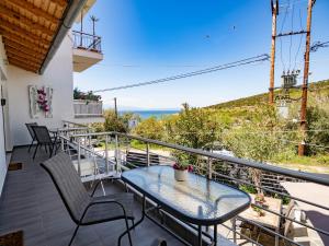 a patio with a table and chairs on a balcony at Doukas Apartments & Studios in Skala Marion