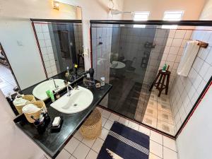 a bathroom with two sinks and a shower at Loft NOA'House in Canoa Quebrada +14 photos