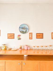 a wooden shelf with glasses and a plate on the wall at Lido di Camaiore-Spacious & Bright 2Bedrooms House in Lido di Camaiore +7 photos