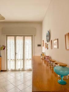 a large room with chairs and a large glass door at Lido di Camaiore-Spacious & Bright 2Bedrooms House in Lido di Camaiore