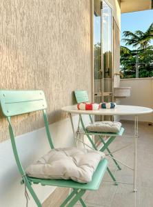 a table and two chairs with a table and a table at Lido di Camaiore-Spacious & Bright 2Bedrooms House in Lido di Camaiore