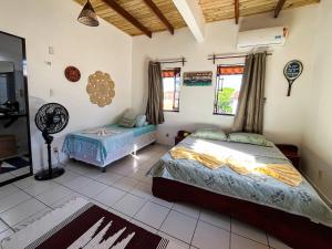 a bedroom with two beds in a room at Loft NOA'House in Canoa Quebrada