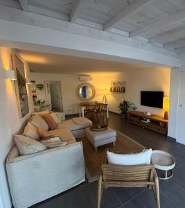 a living room with a couch and a tv at Beach Front House 'Casa Neen' in Corralejo