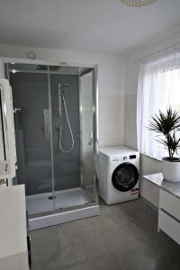 a bathroom with a shower and a washing machine at U Edzia in Kochoń +42 photos