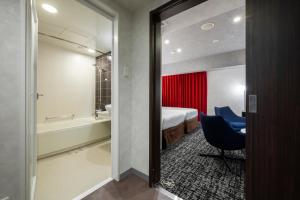 a room with a bathroom with a bed and a chair at Richmond Hotel Namba Daikokucho in Osaka +102 photos