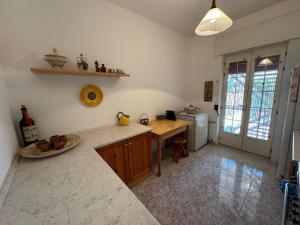 a kitchen with a table and a counter top at Villa Ciaky in Leporano Marina