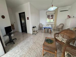 a living room with a table and chairs at Villa Ciaky in Leporano Marina
