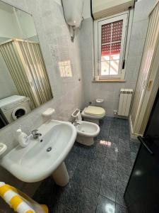 a bathroom with a sink and a toilet at Villa Ciaky in Leporano Marina +18 photos