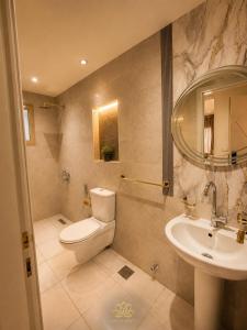 a bathroom with a toilet and a sink at Grand lotus hotel downtown in Cairo