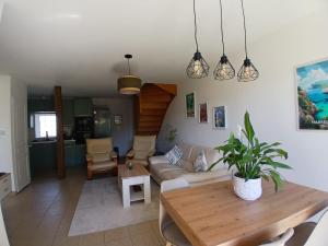 a living room with a couch and a table at L'Escale Orléans Chambres d'hôtes in Orléans
