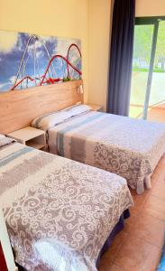 two beds sitting next to each other in a room at Cap Salou Binda Mar Apartment in Salou +30 photos