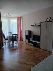 a living room with a table and a dining room at АПАРТАМЕНТ Амира 2 in Balchik