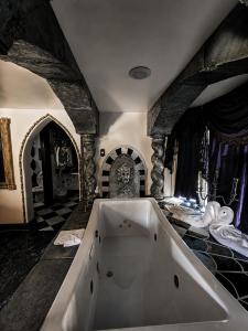 a large bath tub in a room with a stone wall at Castle Wood Cottages in Big Bear Lake +151 photos