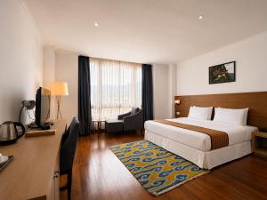 a hotel room with a bed and a desk at Hotel Osel in Thimphu +46 photos