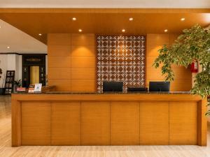 a lobby with a counter with two laptops on it at Hotel Osel in Thimphu