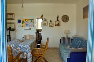 a living room with a table and a couch at Casa Arcobaleno in Marsala