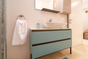 a bathroom with a sink and a counter with a mirror at LOGGIATO HOUSE-Ispica in Ispica +23 photos