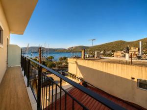 a balcony with a view of a body of water at Dolphin hotel in Korfos
