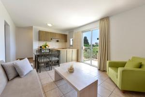 a living room with a couch and a table at Makronisos Village in Ayia Napa