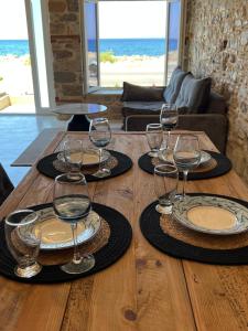a wooden table with wine glasses on top of it at Effies Apartments in Karlovasi